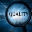 Magnifying glass, and the word Quality